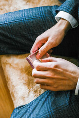 the groom takes out a wedding ring from the box