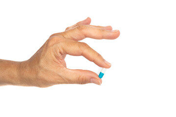 Female hand holds a pill, Isolated on white background