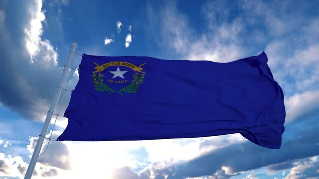 Nevada flag on a flagpole waving in the wind, blue sky background. 4K