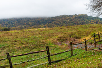 Fototapeta na wymiar Ash Lawn-Highland area with farm rural countryside old fence in Albemarle County, Virginia during autumn fall season with cloudy day and hill