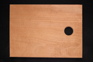 Wooden cutting board on darck background