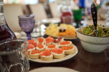 Small appetizers with red caviar and fish
