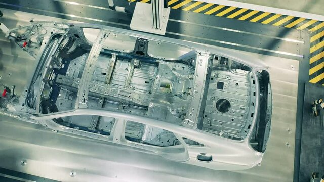 Top view of car body framework at car factory. Automotive factory equipment.