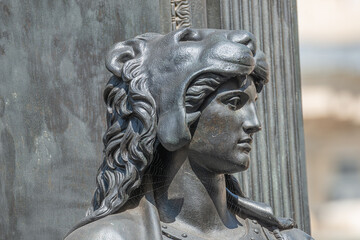 Old statue of a sensual woman warrior, Amazonian, as defender with lion head and club at the Neumarkt in downtown of Dresden, Germany, details, closeup