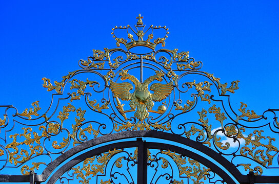 Golden two-headed eagle and crown on the gates of the Great Catherine Palace. Russia Pushkino 08/17/2020