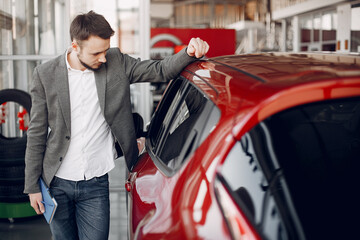 Man buying the car. Businessman in a car salon
