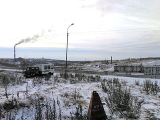 warm winter on the river Bank with a view of the village of North Russia