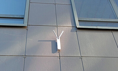 Outdoor wi-fi router on the wall of the house