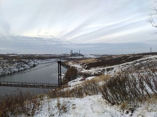 warm winter on the river Bank with a view of the village of North Russia