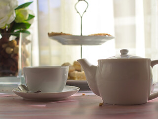 Tea and spanish christmas candies as cortadillos and cakes on pink marble table