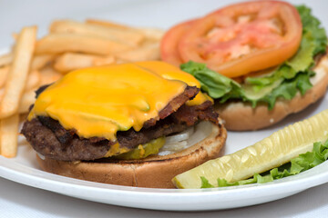 Bacon Double Cheeseburger with a side of French Fries and and a dill pickle