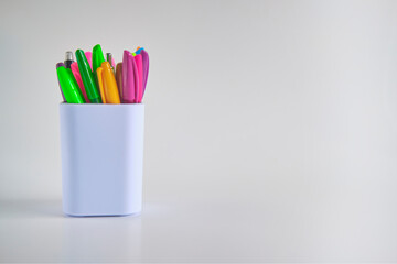 Pens in a white container cup