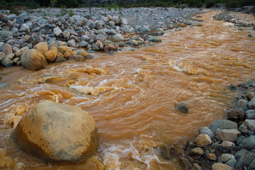 Unique yellow river called River of Gold due to the presence of iron, flowing along the rocky valley in La Rioja, Argentina. 