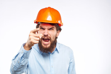 Man in an orange helmet shirt Engineering work construction cropped view