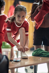 A little girl posing for a photo while preparing for a training. Children team sport