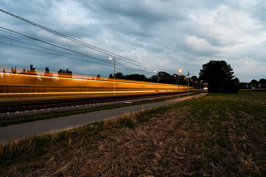 Long-term exposure of a yellow streetcar during twilight.