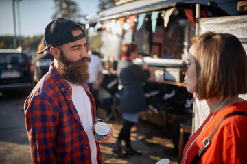 hipster having a conversation with a cool female, wearing sunglasses