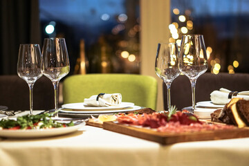 Nicely served New Year's table in the restaurant. Christmas night in a cafe or at home. Stock photo for design