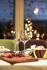 Nicely served New Year's table in the restaurant. Christmas night in a cafe or at home. Stock photo for design