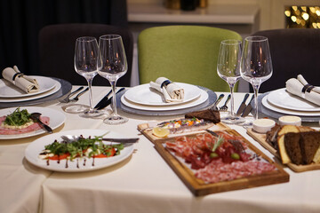 Nicely served New Year's table in the restaurant. Christmas night in a cafe or at home. Stock photo for design