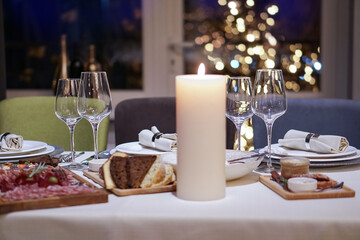Nicely served New Year's table in the restaurant. Christmas night in a cafe or at home. Stock photo for design