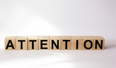 Attention word consisting of building blocks on white background