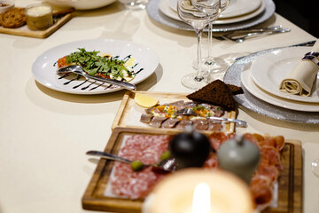 Nicely served New Year's table in the restaurant. Christmas night in a cafe or at home. Stock photo for design