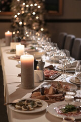 Nicely served New Year's table in the restaurant. Christmas night in a cafe or at home. Stock photo for design