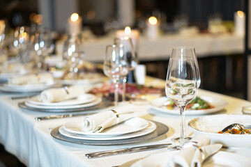 Nicely served New Year's table in the restaurant. Christmas night in a cafe or at home. Stock photo for design