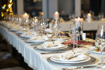 Nicely served New Year's table in the restaurant. Christmas night in a cafe or at home. Stock photo for design