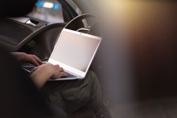 Mobile car service engineer checking car with his laptop on the road. Road assistance concept