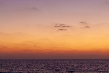 Fototapeta na wymiar calm sea horizon sky clouds sunset landscape
