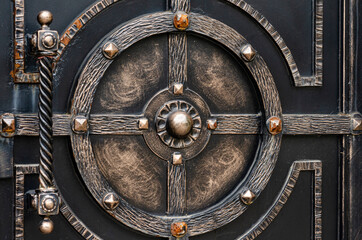 Modern metal gate decorated with wrought iron elements in a retro style