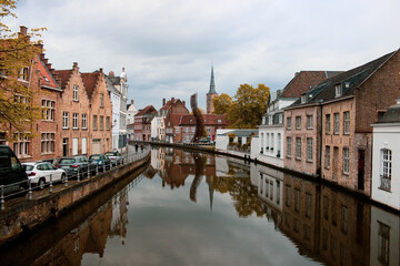 Fototapeta na wymiar Streets of Brugge. Canals of Brugge Belgium. Canal reflecting the streets of the city