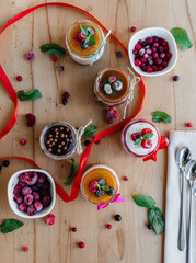 beautifully decorated panna cotta on the table with scattered fruits and decorations