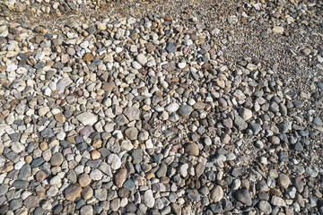 Destroyed road in poor condition requiring repair. Holes in the asphalt are filled with water and puddles. Stock photo background