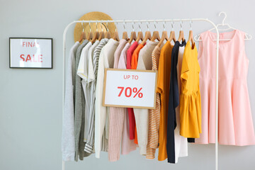 Clothes on the rail and a sale sign. Final sale, discounts