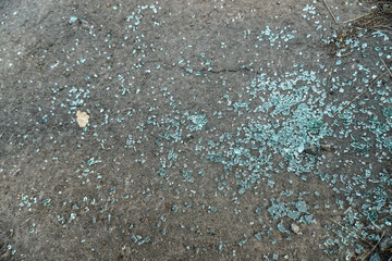 Broken glass in a car accident. small fragments on the asphalt. Photo background for design.