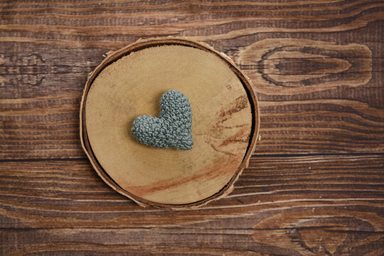 Green crochet heart on wood
