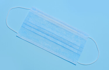 Medical surgical ear mask on a blue background
