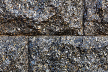 Black granite texture and background in the form of large blocks stacked on top of each other.
