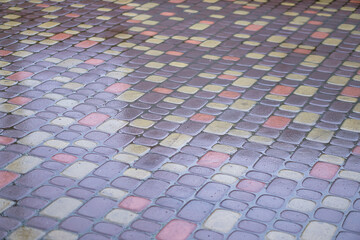 Fototapeta premium Multi-colored paving stones in the water. The texture of stones in the rain. Photo background