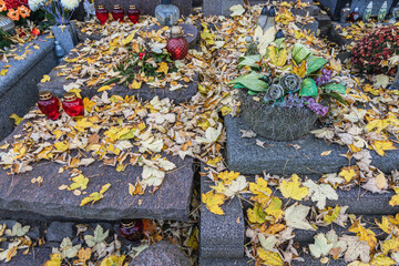 Autumnal leaves on a grave on Wolski Cemetery just before All Saints Day in Warsaw, capital of Poland