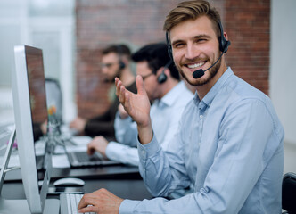 employee with a headset in the workplace in the business center.