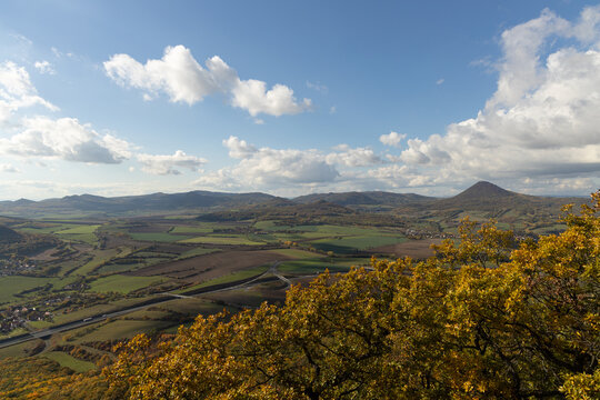 Autumn nature view from mountain Lovos to the horizon with hills and mountains and cloudy sky with trees in foreground