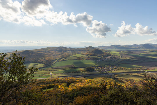 Autumn nature view from mountain Lovos to the horizont with hills and mountains and cloudy sky with trees in foreground
