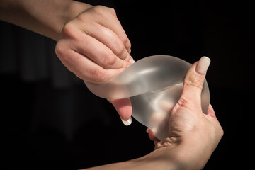 Silicone implant of the female breast during the demonstration of its quality.