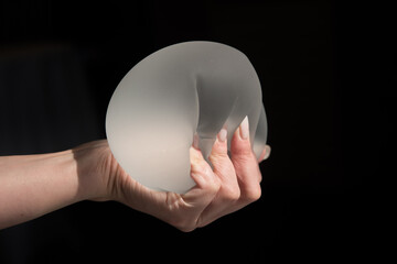 Silicone implant of the female breast during the demonstration of its quality.