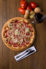 Pepperoni pizza, sliced ​​onions, mozzarella cheese and green olives. Gastronomy photography. Top Photograph.
