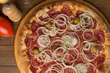Pepperoni pizza, slices of onions, mozzarella cheese and green olives. Gastronomy photography of pizzerias. Top gastronomic photography. Typical Brazilian food.